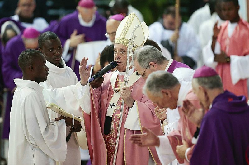 Pope Francis (center) delivers his blessing Sunday as he celebrates Mass at Prince Moulay Abdellah Stadium in Rabat, Morocco. 