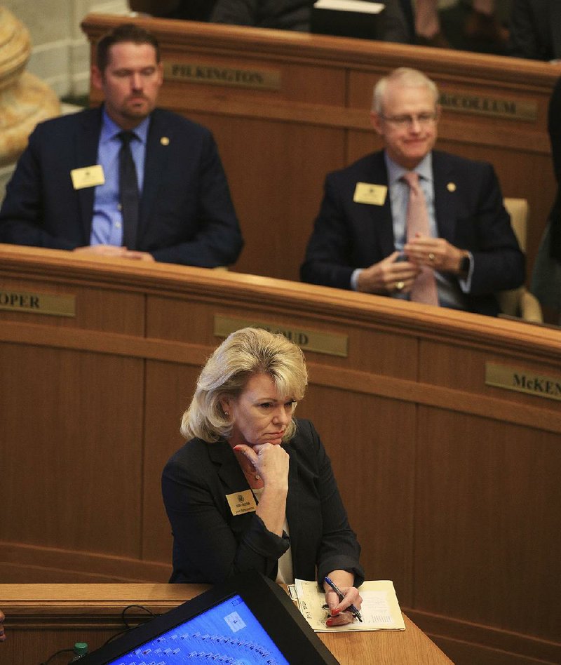 Rep. Robin Lundstrum listens on the House floor to debate about one of two bills she presented Monday that would amend the minimum-wage act approved by voters in November. Both bills failed to pass. More photos are available at arkansasonline.com/42genassembly/. 