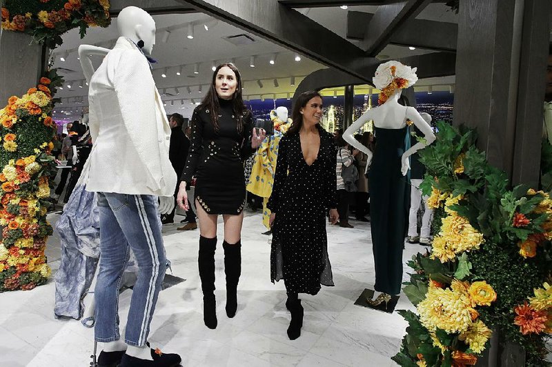 Women shop last month at Neiman Marcus at Hudson Yards development in New York. U.S. retail sales unexpectedly dropped 0.2 percent in February, led by a 4.4 percent drop in sales at garden supply and building material stores. 