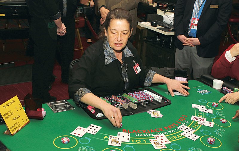 Dealer Stacey Burnett works a blackjack table prior to a ceremony officially starting full-fledged casino gambling at Oaklawn Racing Casino Resort on April 1, 2019. - File photo by Richard Rasmussen of The Sentinel-Record