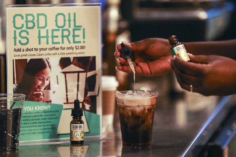 A worker adds cannabidiol (CBD) oil to a drink at a Fort Lauderdale, Fla., coffee shop. The U.S. Food and Drug Administration has scheduled a public hearing on May 31 to discuss how the cannabis product is used in food, drinks and dietary supplements.