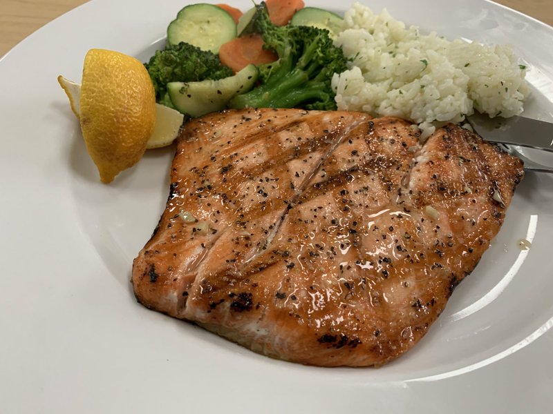 Malibu Cafe’s Grilled Salmon comes with mixed vegetables and herbed rice. Arkansas Democrat-Gazette/Eric E. Harrison
