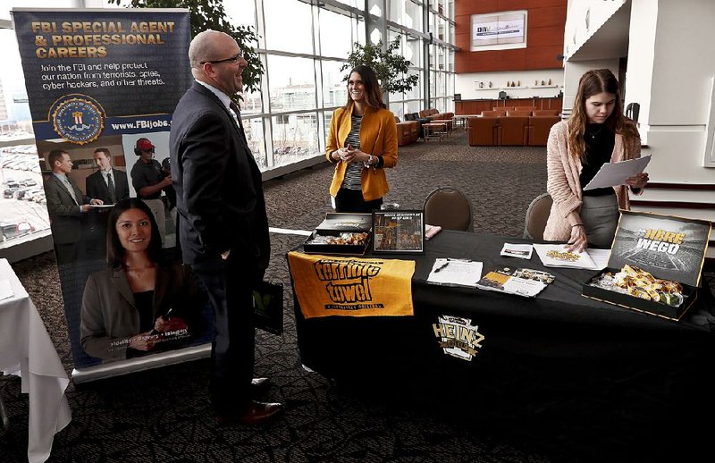 Visitors to the Pittsburgh veterans job fair last month meet with recruiters at Heinz Field in Pittsburgh. U.S. jobs increased by 129,000 in March. Job gains in March are enough to slightly lower the unemployment rate over time, payroll processor ADP said Wednesday. 