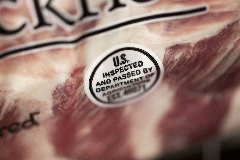 A U.S. Department of Agriculture inspection stamp is displayed recently on a package of baby back pork ribs at a supermarket in Princeton, Ill. 