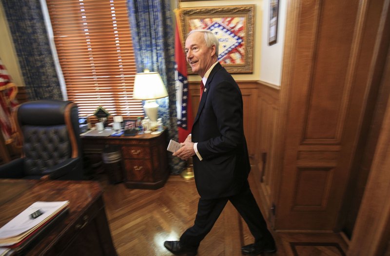   Gov. Asa Hutchinson is in his office at the state Capitol in this file photo.