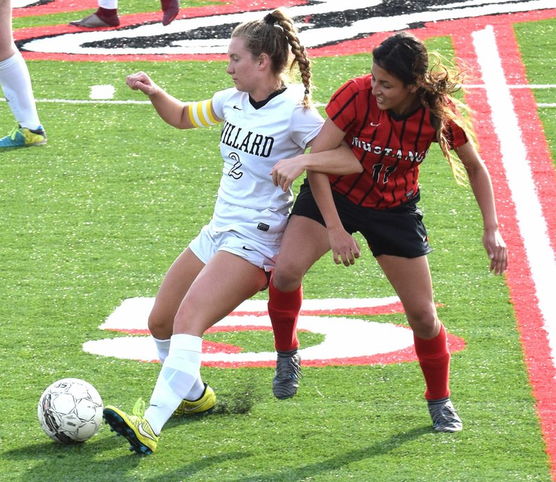 RICK PECK/SPECIAL TO MCDONALD COUNTY PRESS McDonald County's Aaliyah Rubio gets tangled up with a Willard player during the Lady Mustangs' 3-1 loss on March 28 at MCHS.