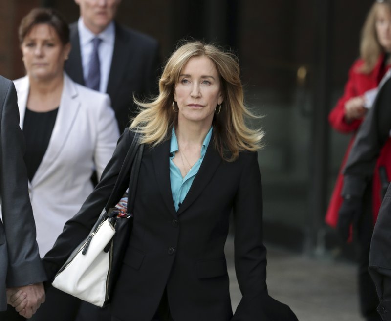 Actress Felicity Huffman departs federal court in Boston on Wednesday, April 3, 2019, after facing charges in a nationwide college admissions bribery scandal. (AP Photos/Charles Krupa)