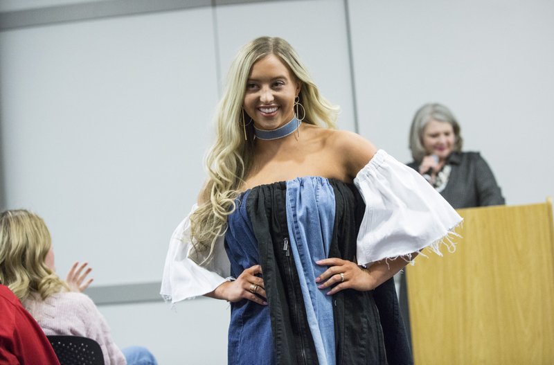 NWA Democrat-Gazette/BEN GOFF @NWABENGOFF
Alexis Windsor, a University of Arkansas freshman from Fort Smith, models a denim dress she made Wednesday, April 3, 2019, during the fashion industry pecha kucha hosted by Northwest Arkansas Fashion Week at Crystal Bridges Museum of American Art in Bentonville. NWA Fashion Week partnered with Arkansas Arts & Fashion Forum to bring together four speakers to talk about sustainability in the fashion industry. After the talks students in the apparel merchandising and product development program at the University of Arkansas modeled clothing items they made from repurposed denim. The event kicks off NWA Fashion Week Spring 2019, which continues with shows in Bentonville through Saturday.