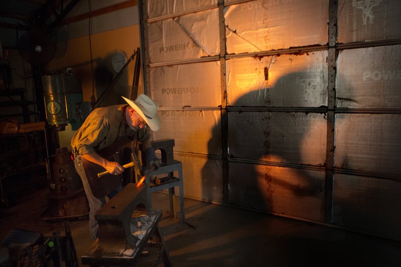 Jerry Fisk shapes a blade for one of his hand made Bowie knives at his workshop near Lockesburg in 2015. (Texarkana Gazette file photo/Evan Lewis)