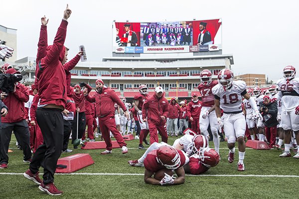 Arkansas players run a drill during practice Saturday, March 30, 2019, in Fayetteville.