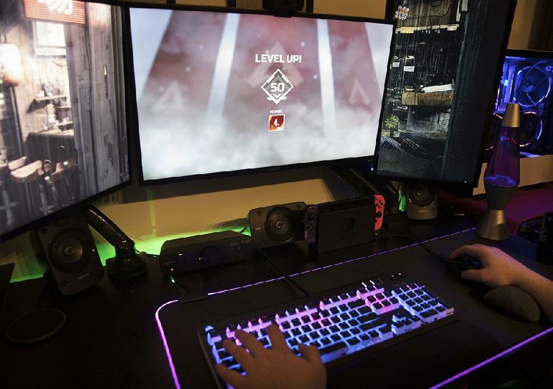 A gamer plays Apex Legends, a new “battle royale”-style game that is raking in the cash, in Jersey City, N.J. 