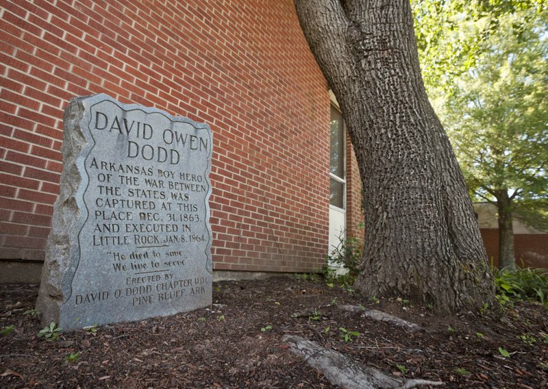 FILE - In this Sept. 18, 2012, file photo, a monument to teenage Confederate spy David O. Dodd, who was executed in 1864, is displayed in front of an elementary school named for him in Little Rock, Ark. Arkansas lawmakers are considering a bill that would make it illegal to remove or alter any military or historical monument on public property, including Confederate monuments, unless a state commission agrees to the changes. The Senate passed the bill 19-10 on Wednesday, April 3, 2019, but it has stalled in a House committee. (AP Photo/Danny Johnston File)