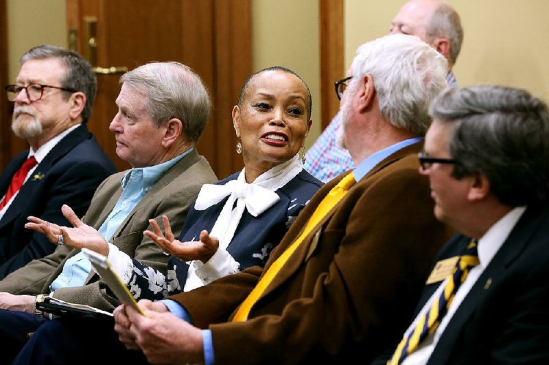 Sen. Joyce Elliott talks Friday with Buddy Chadick, a member of the Arkansas Board of Corrections, before the start of a House Committee on State Agencies and Governmental Affairs meeting where her bill calling for a study of the agency was recommended for approval. More photos are available at www.arkansasonline.com/46genassembly/ 