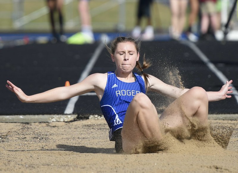 NWA Democrat-Gazette/CHARLIE KAIJO Rogers High runner Georgia Brain, 17, competes in the triple jump during the Whitey Smith Relay Carnival track meet, Friday, April 5, 2019 at Rogers High School in Rogers.