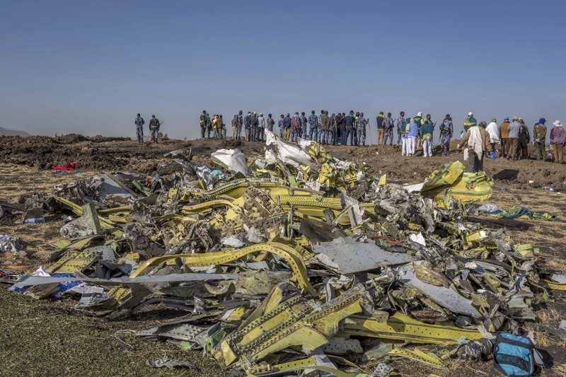 FILE - In this March 11, 2019, file photo, wreckage is piled at the crash scene of an Ethiopian Airlines flight crash near Bishoftu, Ethiopia. Pilots of the Ethiopian Airlines flight encountered problems with their new Boeing jetliner from nearly the moment they roared down the runway and took off. A preliminary report on Thursday, April 4, 2019, by Ethiopian investigators reveals a minute-by-minute narrative of the gripping and confusing scene in the cockpit. (AP Photo/Mulugeta Ayene, File)