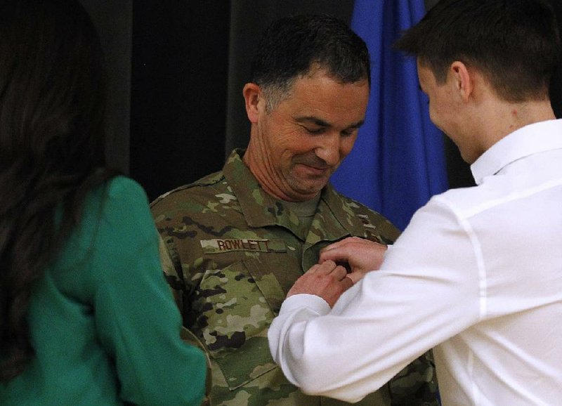 Arkansas Air National Guardsman Brig. Gen. Paul Rowlett has his star pinned on by his son, Jack, as his daughter, Rachel, joins them  onstage during Rowlett’s promotion ceremony Saturday at Little Rock Air Force Base  in Jacksonville. More photos are available at www.arkansasonline.com/47airguard/ 