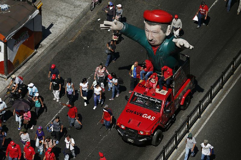 Venezuelans display an inflatable figure of the late President Hugo Chavez on Saturday during a march in Caracas in support of the nation’s current leader, Nicolas Maduro. 