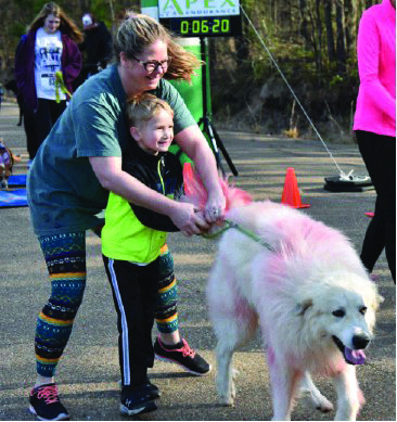 Dash: Katie King and her son Charlie try to hold onto Brutus during last year’s Doggy Dash Fun Run 5K.