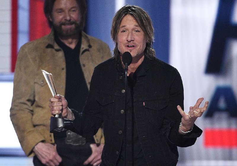 Keith Urban (right) accepts the award for entertainer of the year Sunday as presenter Ronnie Dunn of Brooks & Dunn watches at the 54th annual Academy of Country Music Awards in Las Vegas.