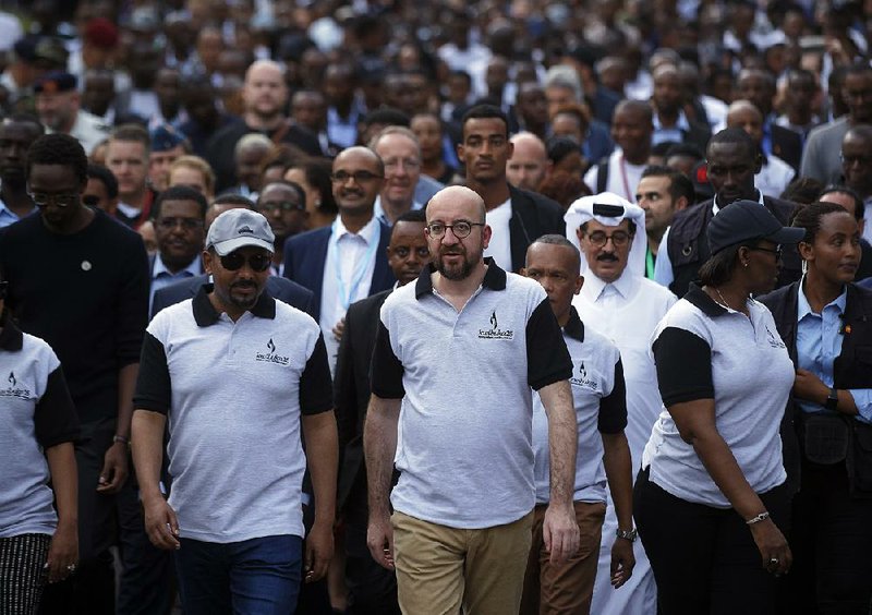 Ethiopian Prime Minister Abiy Ahmed (from front left), Belgian Prime Minister Charles Michel and Rwandan first lady Jeannette Kagame participate in a remembrance event Sunday in downtown Kigali, Rwanda.