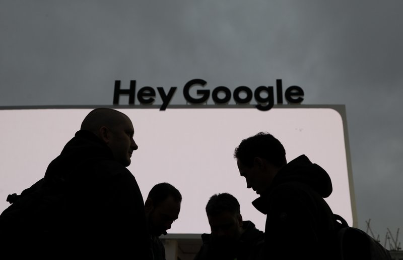 FILE- In this Jan. 5, 2019, file photo people stand in front of the Google tent during preparations for CES International in Las Vegas. Google employees have had more success than other tech workers at demanding change at the company. Google dropped a contract with the Pentagon after employees pushed back on the ethical implications of using company technology to analyze drone video. (AP Photo/John Locher, File)