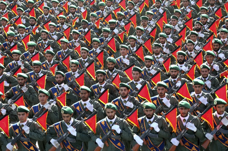 FILE - In this Sept. 21, 2016 file photo, Iran's Revolutionary Guard troops march in a military parade marking the 36th anniversary of Iraq's 1980 invasion of Iran, in front of the shrine of late revolutionary founder Ayatollah Khomeini, just outside Tehran, Iran. The Trump administration is preparing to designate Iran&#x2019;s Revolutionary Guards Corps a &#x201c;foreign terrorist organization&#x201d; in an unprecedented move that could have widespread implications for U.S. personnel and policy. U.S. Officials say an announcement could come as early as Monday, April 8, 2019, following a months-long escalation in the administration&#x2019;s rhetoric against Iran. The move would be the first such designation by any U.S. administration of an entire foreign government entity. (AP Photo/Ebrahim Noroozi, File)