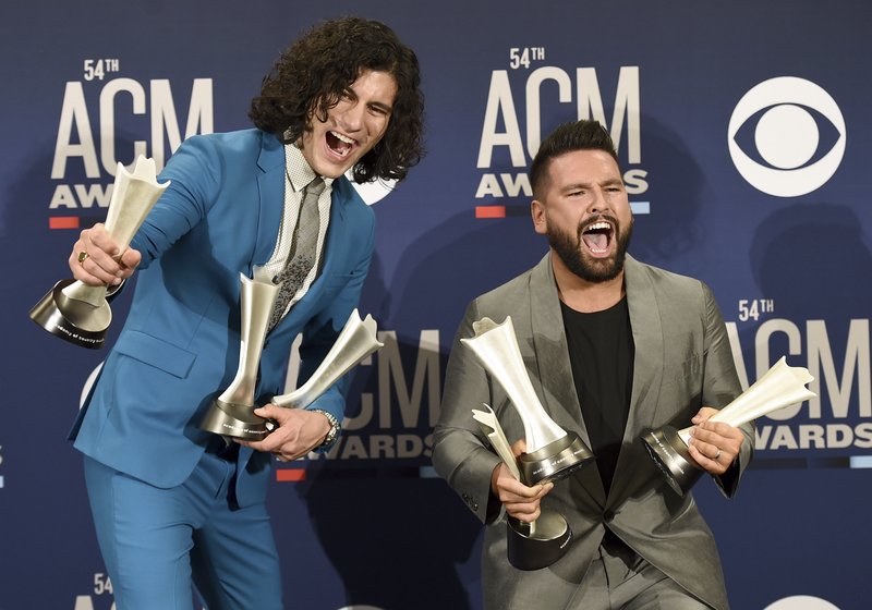 Dan Smyers, left, and Shay Mooney, of Dan + Shay, pose in the press room with the awards for song of the year and single of the year for &quot;Tequila,&quot; and duo of the year at the 54th annual Academy of Country Music Awards at the MGM Grand Garden Arena on Sunday, April 7, 2019, in Las Vegas. (Photo by Jordan Strauss/Invision/AP)
