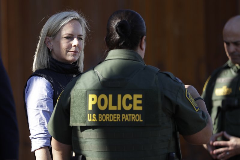FILE - In this Friday, Oct. 26, 2018, file photo, U.S. Department of Homeland Security Secretary Kirstjen Nielsen, left, speaks with Border Patrol agents near a newly fortified border wall structure in Calexico, Calif. In a tweet on Sunday, April 7, 2019, President Donald Trump said he's accepted Nielsen's resignation. (AP Photo/Gregory Bull, File)