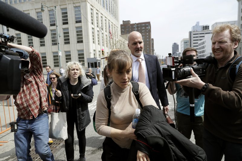 Actress Allison Mack leaves Brooklyn federal court Monday, April 8, 2019, in New York. Mack pleaded guilty to racketeering charges on Monday in a case involving a cult-like group based in upstate New York. The trial is expected to detail sensational allegations that the group, called NXIVM, recruited sex slaves for its spiritual leader, Keith Raniere.(AP Photo/Mark Lennihan)

