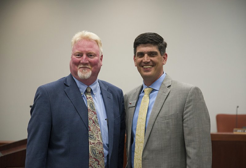 Dyun Long (left) with Magnolia Superintendent John Ward after the 23-year Magnolia coach was named new Panther AD.