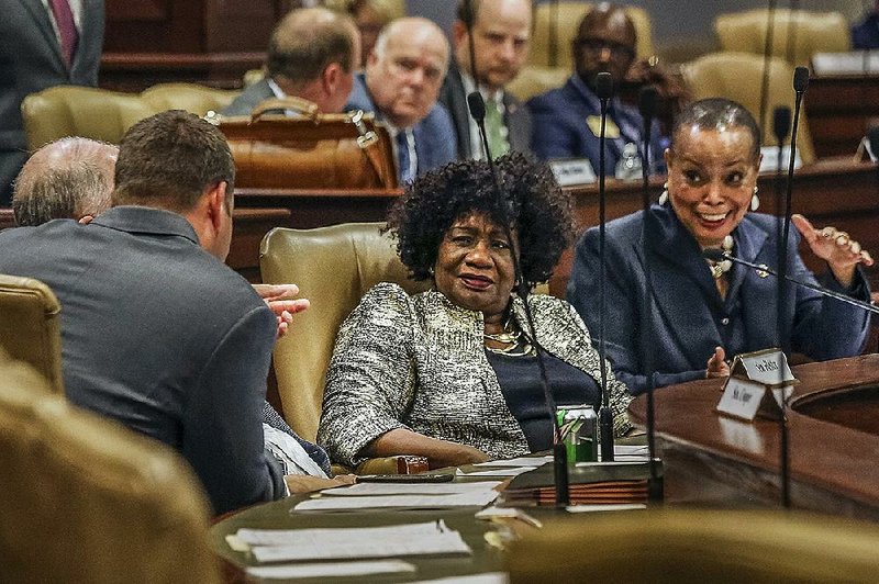 Sens. Linda Chesterfield (center) and Joyce Elliott (right), both Democrats from Little Rock, talk to Sen. Bart Hester, R-Cave Springs, during the Joint Budget Committee meeting Monday. More photos are available at arkansasonline.com/49genassembly/ 