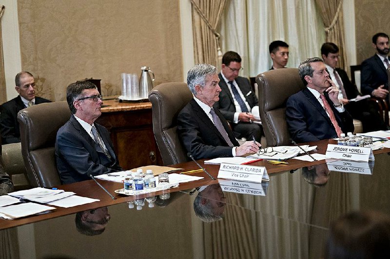 Federal Reserve Vice Chairman Richard Clarida (from left), Chairman Jerome Powell and Vice Chairman of Supervision Randal Quarles listen to the discussion Monday at a board meeting in Washington on the banking-regulation proposal. 