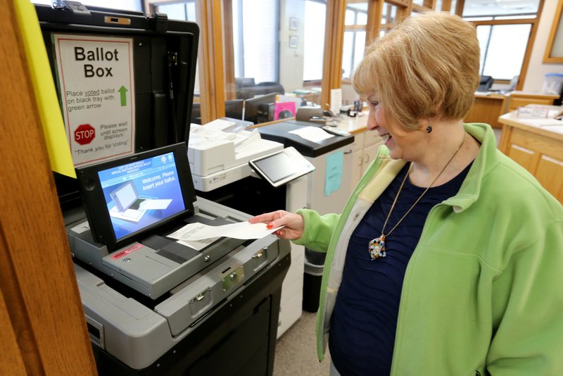 File photo/NWA Democrat-Gazette/DAVID GOTTSCHALK Suzie Jenkins casts her ballot Thursday while voting early in the city of Fayetteville's bond referendum inside the Washington County Clerk's Office at the Washington County Courthouse in Fayetteville. Early voting in Fayetteville's bond referendum wrapped Monday and voters can go to any of six polling sites to vote on Election Day today. Voters are being asked to continue the city's 1-cent sales tax to pay for about $226 million over 10 bond issues for various projects.