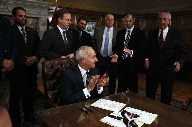 Gov. Asa Hutchinson applauds legislators for their work while signing tax bills into law Tuesday, April 9, 2019, during a ceremony at the state Capitol. More photos from that day at the state Legislature are available at arkansasonline.com/410genassembly/