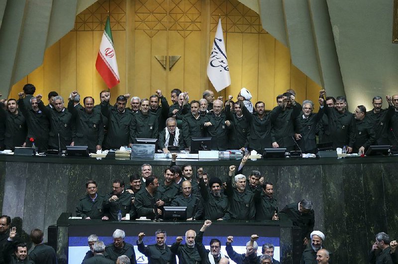 Wearing the uniform of the Iranian Revolutionary Guard, lawmakers chant “Death to America” during a session of parliament Tuesday in Tehran, Iran. 