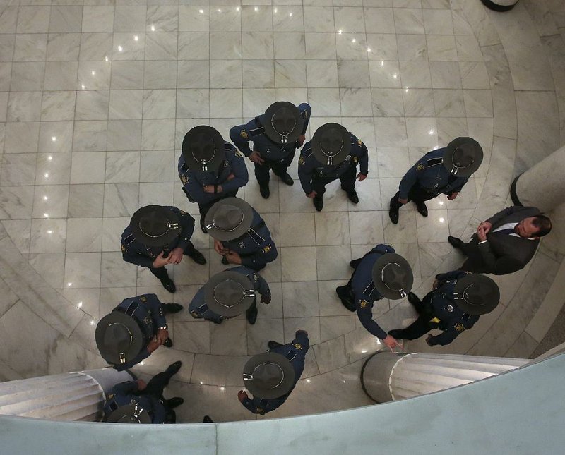 Arkansas Democrat-Gazette/THOMAS METTHE -- 4/9/2019 --
Officers with the Arkansas State Police gather in the Capitol before the start of the legislature session on Tuesday, April, 9, 2019, at the State Capitol in Little Rock. 