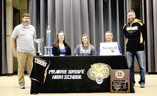 Shelley Williams special to the Enterprise-Leader Prairie Grove senior Megan Thompson (center) signs with the University of Arkansas at Fort Smith for track and field as well as cross country. Thompson was accompanied by Prairie Grove head cross country coach Darrin Chandler (left); her parents Jennifer and Ronny Thompson; and Prairie Grove assistant coach for cross country plus track and field Keith Bostian.
