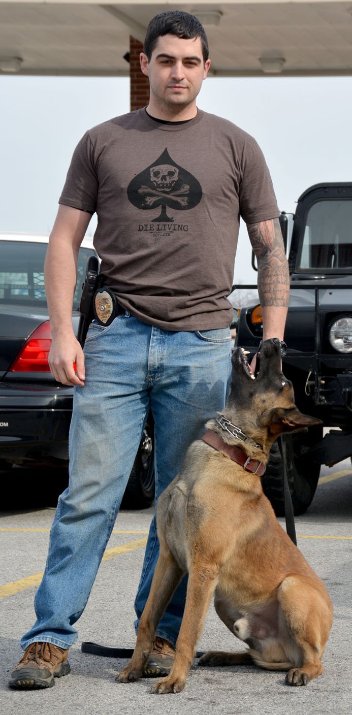 Hunter McFerrin/Herald-Leader After letting him play with his toy for a few minutes, Officer Travis Luper manages to get his K-9 partner, Frenkie, to sit still for a picture. Luper and Frenkie makeup the department's only other K-9 team, a role they've filled for about the last year and a half.