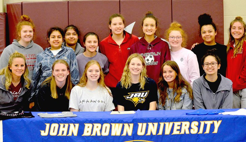 Jana Claybrook Special to the Enterprise-Leader/Lincoln girls basketball players and coaches join senior Jessica Goldman in celebrating her official commitment to play women's college basketball at John Brown University. Goldman signed a national letter of intent on Tuesday, March 26.