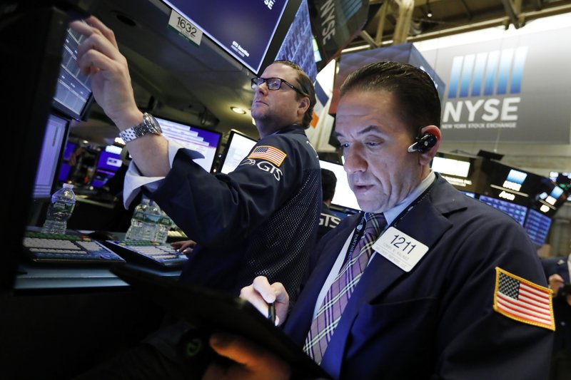 In this April 2, 2019, file photo specialist Gregg Maloney, left, and trader Tommy Kalikas work on the floor of the New York Stock Exchange.  (AP Photo/Richard Drew, File)