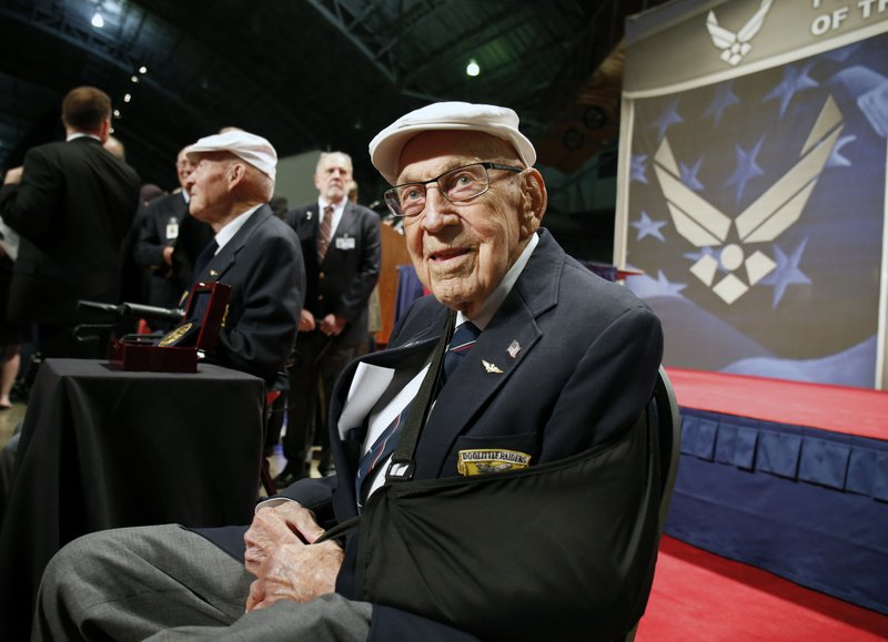 In this April 18, 2015, file photo, two members of the Doolittle Tokyo Raiders, retired U.S. Air Force Lt. Col. Richard "Dick" Cole, seated front, and retired Staff Sgt. David Thatcher, seated left, pose for photos after the presentation of a Congressional Gold Medal honoring the Doolittle Tokyo Raiders at the National Museum of the U.S. Air Force at Wright-Patterson Air Force Base in Dayton, Ohio. 