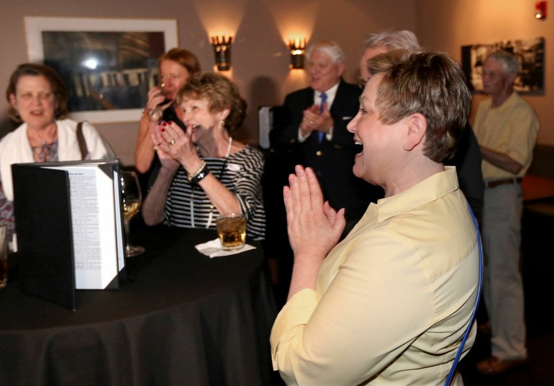 Sara Koenig celebrates Tuesday after hearing early results of a special election at a watch party for Fayetteville’s bond referendum at Bordinos. Residents headed to the polls to decide whether to continue the city’s 1 percent sales tax to pay for about $226 million in bond issues for various projects.