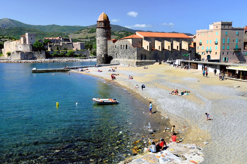 Collioure’s sand-and-pebble beach ends at the Notre-Dame des Anges church, a view that has inspired many modern artists. Photo by Cameron Hewitt via Rick Steves' Europe