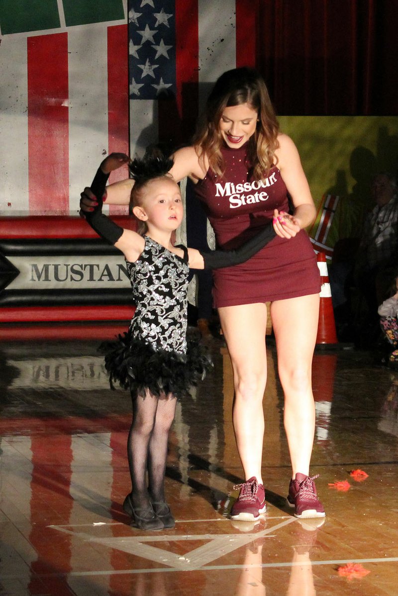 MEGAN DAVIS/MCDONALD COUNTY PRESS An aspiring dancer displays her form with the assistance of her hero.