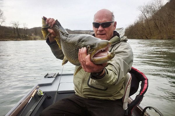 Louis Campbell holds up a personal-record brown trout on the Norfork River in March 2019. 
