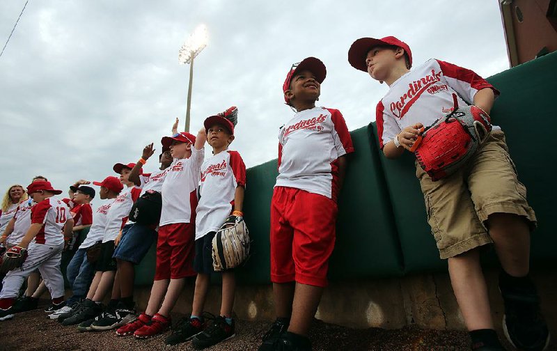 Members of the Sylvan Hills-Sherwood Optimist Club Cardinals check out the field Thursday at Dickey Stephens Park in North Little Rock before the Arkansas Travelers’ home opener against the Tulsa Drillers.