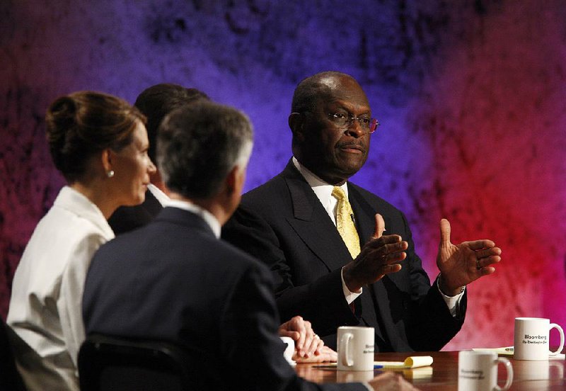 Herman Cain (right), shown speaking during a presidential debate in 2011, faces an uphill battle to join the Federal Reserve board of governors after four Senate Republicans announced they would oppose him if he’s nominated. 