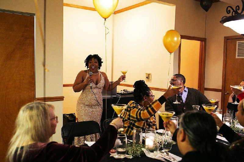 A Table For Twenty co-founder Stacie Thompson proposes a toast during a cannabis-infused dinner at a private home in the Humboldt Park neighborhood in Chicago in February. 