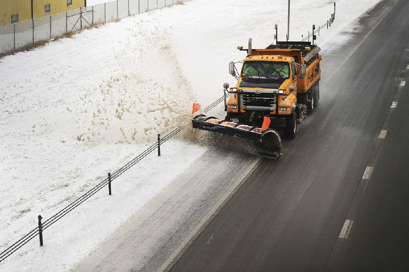 Snowplows clear Interstate 29 on Thursday in Sioux Falls, S.D. 