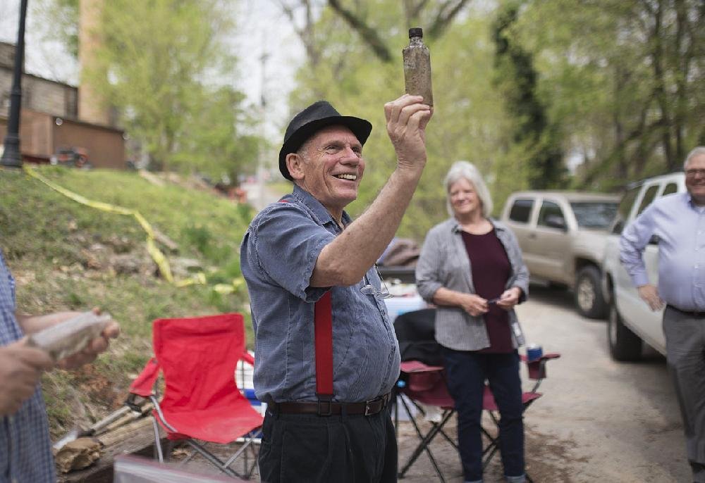 Keith Scales, who leads ghost tours at the Crescent Hotel, holds up a jar pulled from the excavation site Thursday behind the Eureka Springs hotel. Scales said he hopes to incorporate the archaeological finds into his tours.